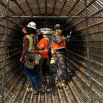 Workers tying rebar cage