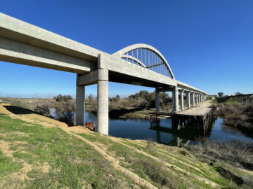 An image of the San Joaquin River Viaduct and it's signature arches spanning the river below.