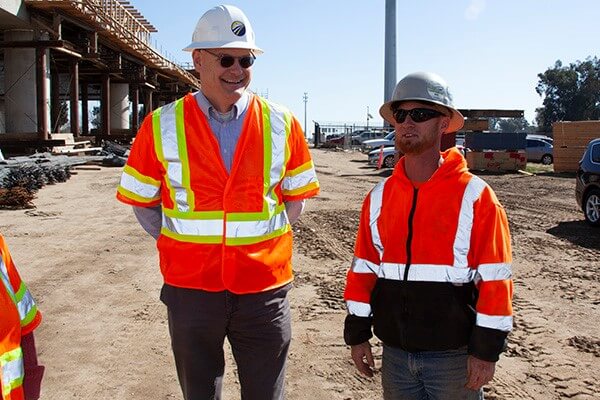 CEO Brian Kelly at construction site with worker