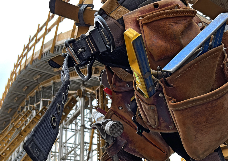 construction worker belt with tools in front of arch structure