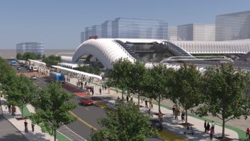 Rendering showing an interpretation of the future Fresno Station, featuring shaded, walkable and bikeable access. The station's canopy arches above the entrance, with a large sign which says "Fresno" on top.