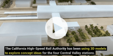 Image of 3D model of train station with video play button 