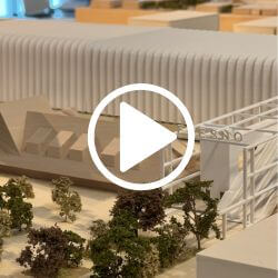 3D model of a high-speed rail station with a play button over the image to prompt reader to click and watch the video.