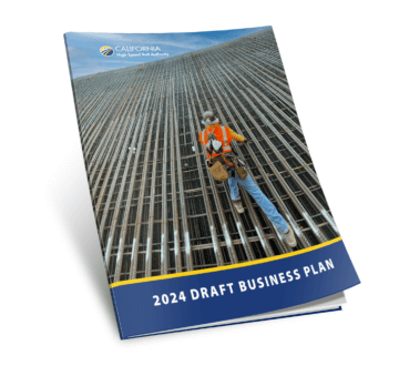 the 2024 draft Business Plan front cover with a slight curl to the bottom right corner