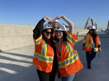 Layla Namak and Shane Chavez pose in a heart shape on the Cedar Viaduct.