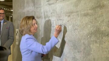 Speaker Emerita Nancy Pelosi signs wall in the Salesforce Transit Center trainbox.