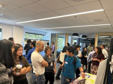 People discuss an information board at a California High-Speed Rail Authority Open House.