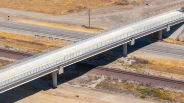 Taken from above via drone, the Avenue 88 Grade Separation predominates the photo, taking center stage. Parched earth surrounds it on all sides, as it passes over State Route 43 and the BNSF freight railroad tracks below, as well as the eventual location of high-speed rail tracks.