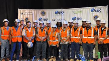 Central Valley Training Center graduates posing in front of a backdrop on stage.