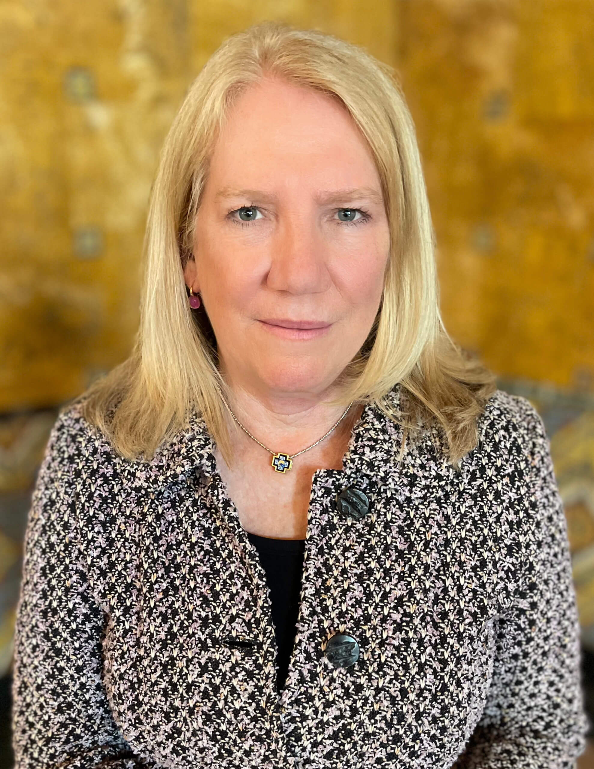 Headshot of Southern California Regional Director LaDonna DiCamillo smiling in front of a mustard yellow background.